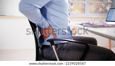 Back Pain Bad Posture Man Sitting In Office Royalty-Free Stock Photo #2239028587