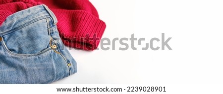 blue jeans and a burgundy sweater on a white background, copy space