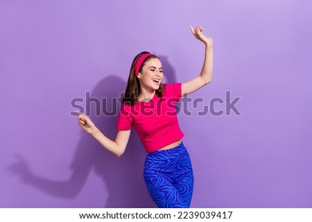 Photo of carefree positive pretty girl have fun dancing chilling free time isolated on violet color background