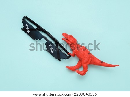 Toy tyrannosaurus rex with Pixelated 8 bit sunglasses on pastel background