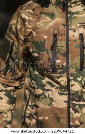 Ukrainian soldier in a warm fleece army jacket. Special insulating clothing for the military
