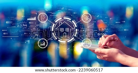 Real estate theme with person using a smartphone in a city at night