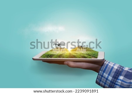 Agriculture drone fly to sprayed fertilizer on the Sugarcane fields. smart farmer use drone for various fields like research analysis, terrain scanning technology, smart technology concept. Royalty-Free Stock Photo #2239091891