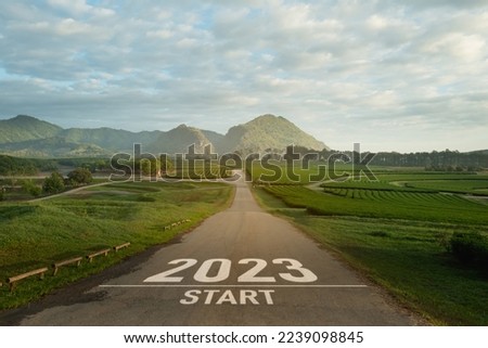Happy new year 2023,2023 symbolizes the start of the new year. The letter start new year 2023 on the road in the nature fresh green tea farm mountain environment ecology or greenery wallpaper concept.