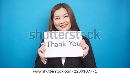 Asian business woman holding paper the text Thank You with happy smile face in sale advertising and copy space