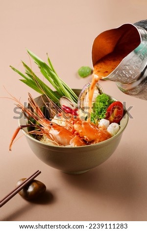 Seafood Tom yum kung noodle .  Traditional Thai style food., south east Asia food.Seafood Tom yum kung. Tom Yum Goong Yai Spicy Giant Tiger Prawn Soup, Lemongrass,Lime Juice, Bird’s Eye Chilies Royalty-Free Stock Photo #2239111283