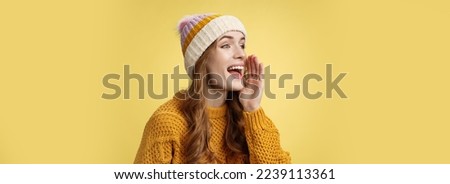 Attractive happy girlfriend shout call boyfriend standing far away take pic, turning left scream hold hand near opened mouth seek friend yelling loudly, search someone, yellow background.