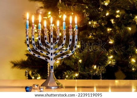 Hanukkah is celebrated with a menorah nine burning candles.