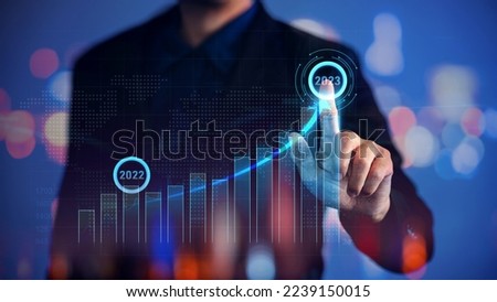 Business target set goals and achievement growth year 2022 to 2023 with digital augmented reality graphics, positive indicators. Futuristic technology concept for business trend, investment strategy. Royalty-Free Stock Photo #2239150015