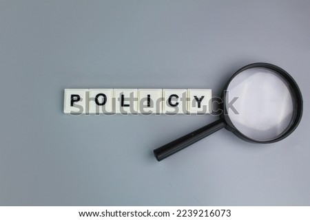 magnifying glass with alphabet letters of the word policy. Business privacy legal documents, advice information concepts