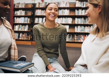 Student, friends and book discussion in library with smile for education, learning or knowledge at university. Group of happy women enjoy conversation, book club or social study for research project Royalty-Free Stock Photo #2239225393