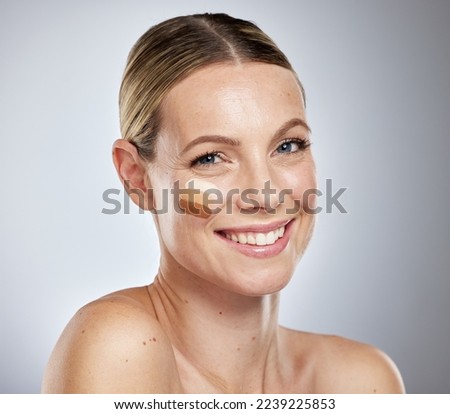 Makeup, beauty and portrait of woman with foundation to test skin color, tone and contour on face. Skincare, cosmetology and happy girl with facial concealer, beauty products and cosmetics in studio
