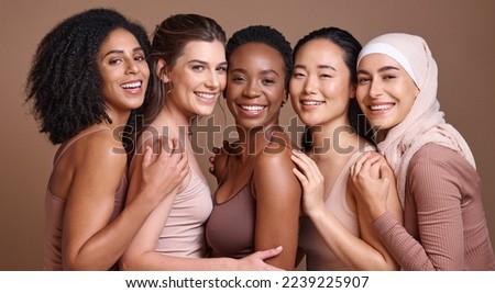 Skincare, diversity and women hug portrait for inclusivity, happiness and healthy skin texture. Interracial beauty and model group with woman in hijab smile for cosmetic campaign in brown studio Royalty-Free Stock Photo #2239225907
