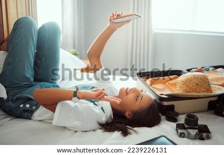 Peace, phone or girl taking selfie on a bed for social media with luggage in airbnb, apartment or hotel room. Relax, freedom or happy traveler smiles taking pictures with hand gesture or sign alone