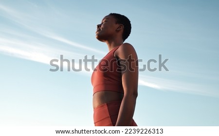 Fitness, meditation and woman on blue sky to breathe fresh air, freedom and energy to exercise, workout and do yoga or cardio training outdoor in nature. Black female take breath for mental health Royalty-Free Stock Photo #2239226313