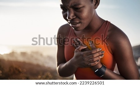 Heart pain, fitness and black woman with an injury from cardio, running and nature workout in Germany. Asthma, health and African runner with heart attack risk during training on the mountain Royalty-Free Stock Photo #2239226501