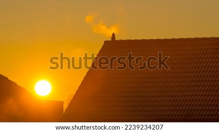 Foggy sunrise along the roof of an house in sunlight in winter, Almere, Flevoland, The Netherlands, December, 2022