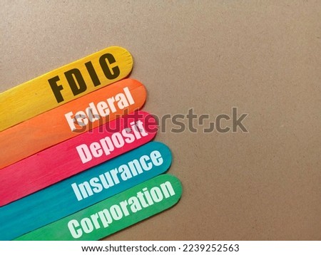 Business FDIC federal deposit insurance corporation concept at ice cream sticks isolated brown background. Royalty-Free Stock Photo #2239252563