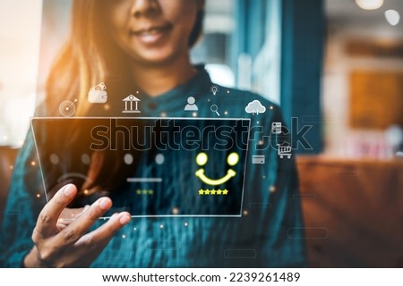 concept of Customer service and Satisfaction Ratings and Evaluations. ,smart business woman man giving rating and review with happy smiley face on visual touch screen 
