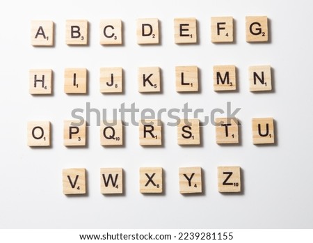 wooden letters, alphabetic letters in wooden order drawn on a white background.Selective focus.