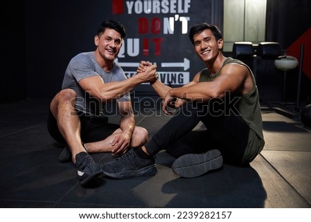 young athletic men meeting in the gym and shaking hands after workout Royalty-Free Stock Photo #2239282157