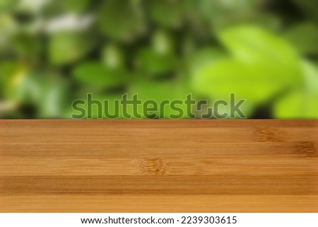 Bamboo table top front view with blurred nature background