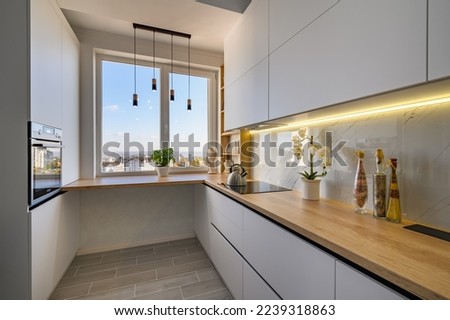 A modern minimalist white studio with a kitchen that is both functional and stylish Royalty-Free Stock Photo #2239318863