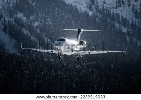 Private jet landing in the swiss alps during winter season. The jet brings the guest to their luxury ski vacation in switzerland Royalty-Free Stock Photo #2239319033