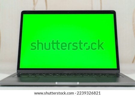 Close up of a laptop computer with green screen