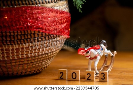 inscription 2023 wooden cubes with New Year decorations, background