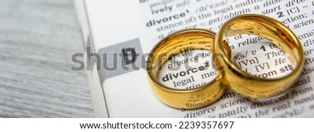 Divorce and separation concept. Two golden wedding rings. Dictionary definition	
