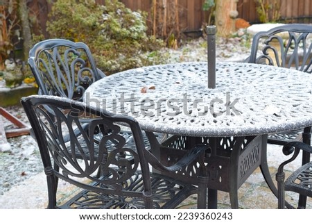 Garden furniture covered with snow.