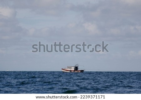 fishing boat on the high seas and blue sky