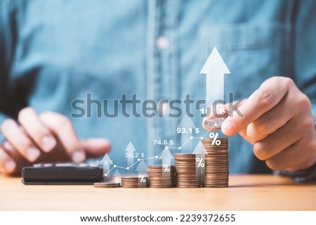Businessman stacking money coins with up arrow and percentage symbol for financial banking increase interest rate or mortgage investment dividend from business growth concept. Royalty-Free Stock Photo #2239372655
