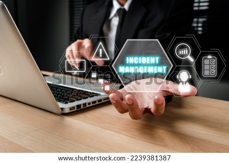 Incident Management process Business Technology concept, Business person hand holding incident management icon on virtual screen. Royalty-Free Stock Photo #2239381387