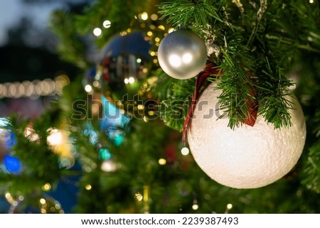 Christmas ball decorate on pine tree branch at night merry christmas blurred bokeh background