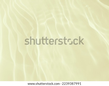 Closeup​ blur​ abstract​ of​ surface​ blue​ water​ for​ background. Reflection​ on​ surface​ blue​ water​ in​ the​ sea. Reflection​ of​ sunlight​ with​ surface​ blue​ water​ in​ the​ swimming​ pool.