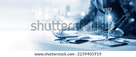 Goal of business new year in 2023, Investor, Businessman analysis economic and calculates financial data and target for long-term investments and profitability in future on digital data network. Royalty-Free Stock Photo #2239405919