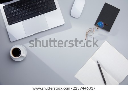 Assorted office supplies and coffee on the desk
