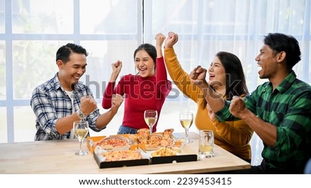 Group of overjoyed Asian friends laughing, screaming, cheering up, celebrating victory, having fun time together in the party.