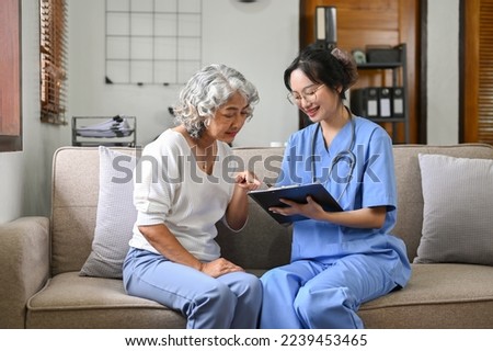 Happy 60-year-old elderly woman and a female doctor in the clinic office, sitting on the sofa, talking and discussing the treatment plan together.