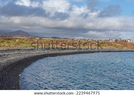 Views of the pebble beach, Playa de Los Colmenares, found along one of the most popular coastal hiking paths located between Montana Amarilla and Amarilla Golf resort, Tenerife, Canary Islands, Spain