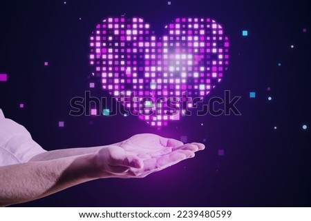 Close up of male hand holding abstract glowing purple pixel heart on blurry background. Health, cardiology and game interface concept