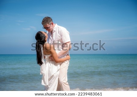 Couples and romantic moments in honeymoon trip At the beautiful beach and sea.Man and Women in beautiful white dresses On beach. Honeymoon concept.