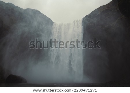 Wonderful waterfall on steep rock landscape photo. Beautiful nature scenery photography with on background. Idyllic scene. High quality picture for wallpaper, travel blog, magazine, article