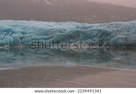Huge glacier near frozen lake landscape photo. Beautiful nature scenery photography with mountain on background. Idyllic scene. High quality picture for wallpaper, travel blog, magazine, article