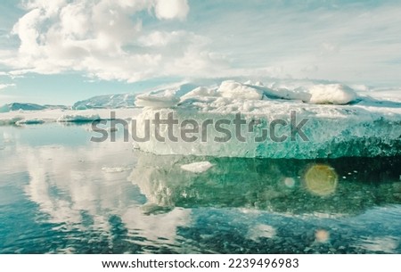 Glacier in mirror sea water landscape photo. Beautiful nature scenery photography with cloudy sky on background. Idyllic scene. High quality picture for wallpaper, travel blog, magazine, article