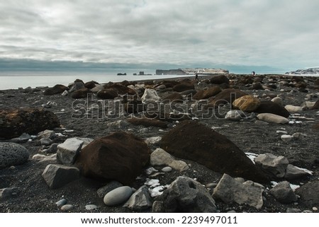Beach with huge rocks landscape photo. Beautiful nature scenery photography with cloudy sky on background. Idyllic scene. High quality picture for wallpaper, travel blog, magazine, article