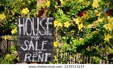 A chalkboard sign advertising a house for sale or for rent, on Mindoro Island in the Philippines.