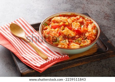 Bacalao al ajoarriero Cod with peppers and tomato sauce closeup on the bowl on the table. Horizontal
